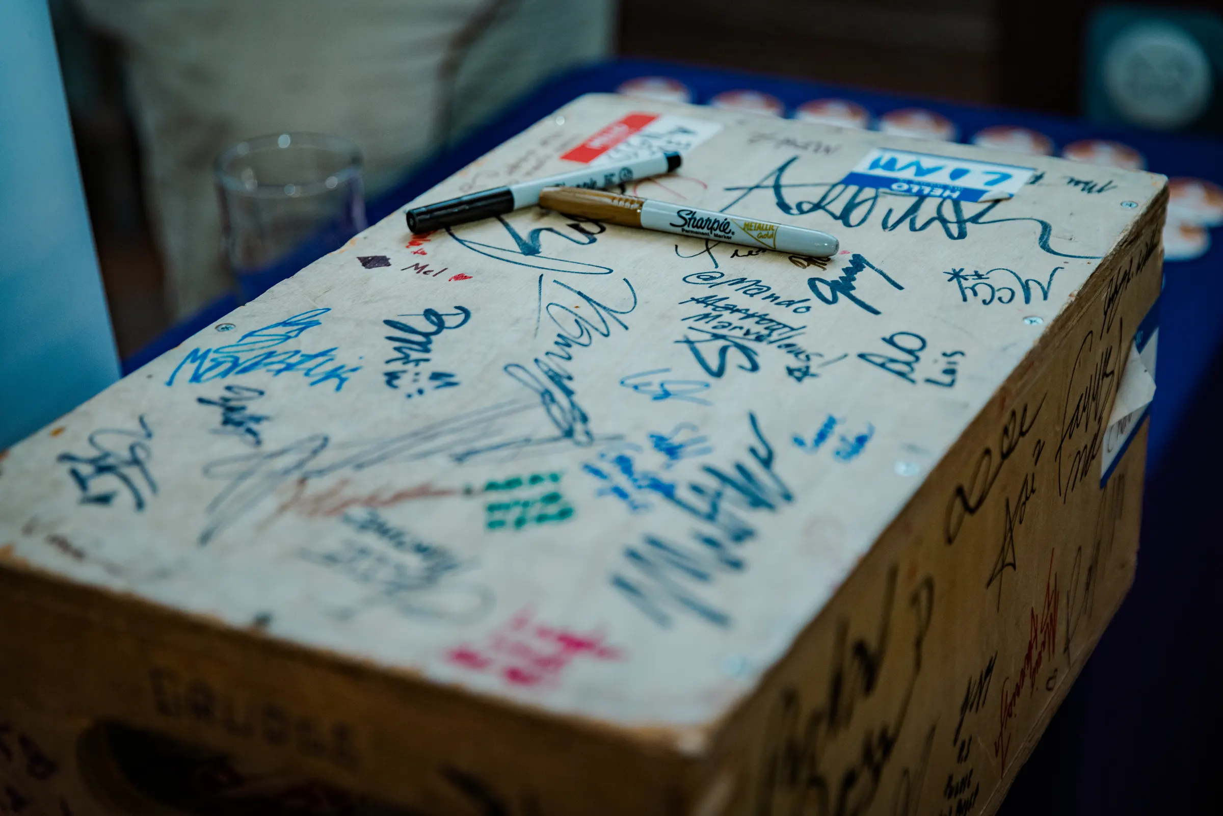 A wooden box covered in signatures from the night