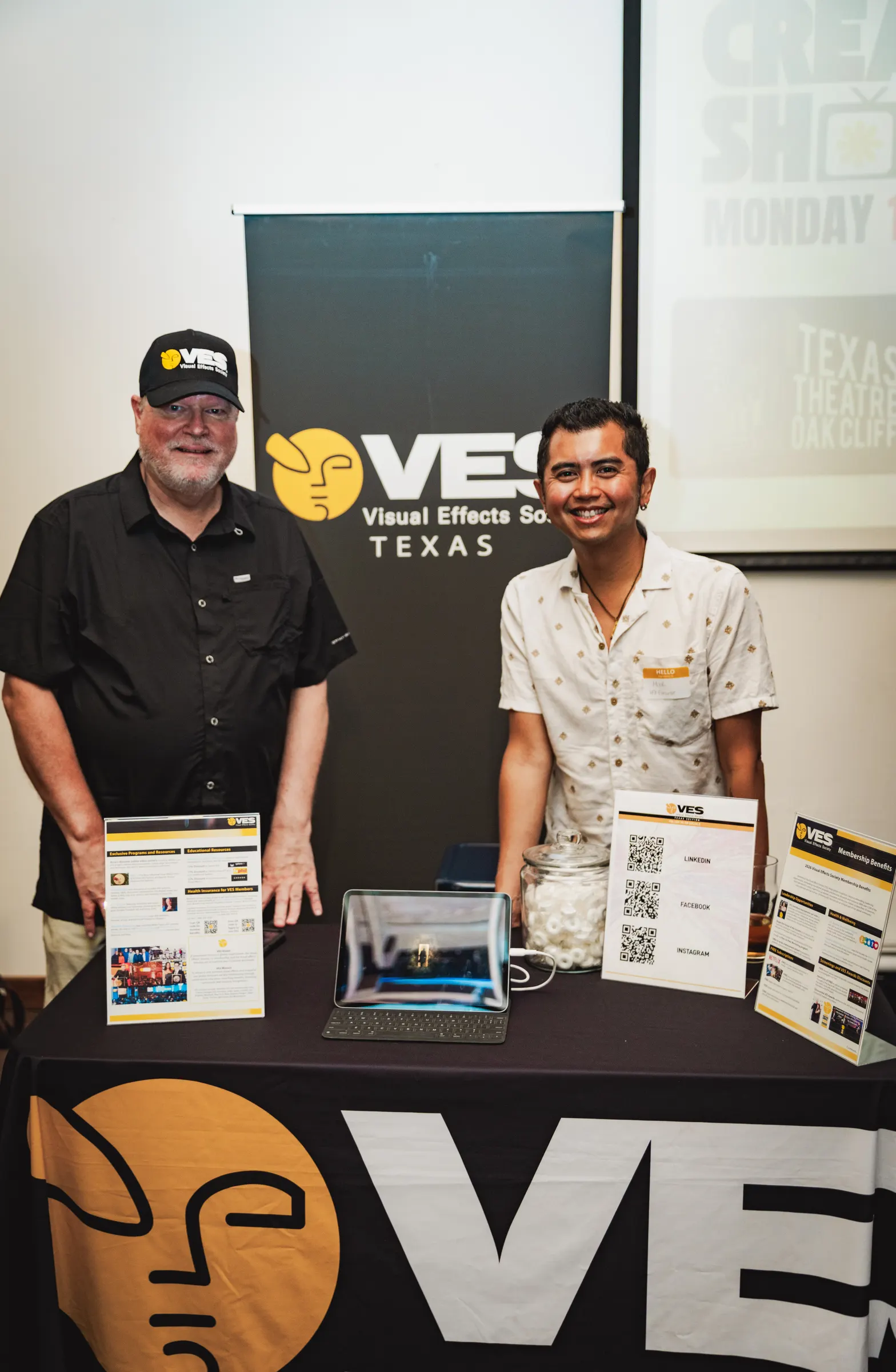 Two creatives talking at the VES Texas table