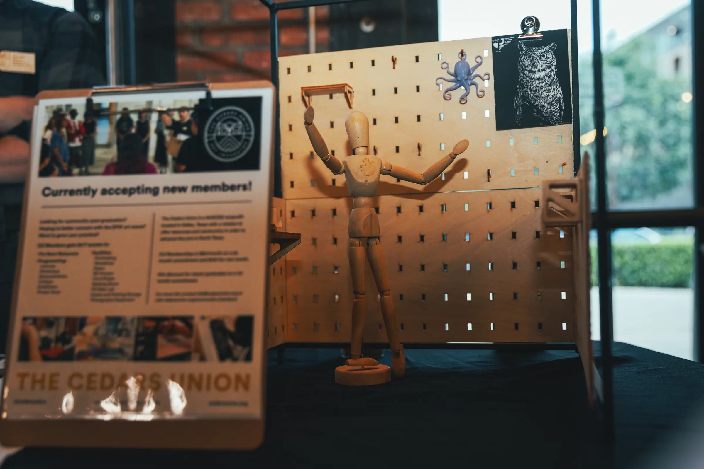 A drawing mannequin and artwork at The Cedars Union table